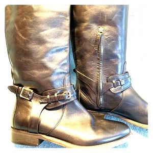 Burberry bridle strap knee height riding boots.